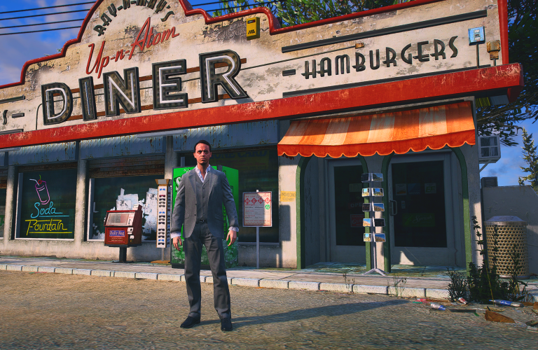 Jack Feebs in a gray suit outside the Up-n-Atom diner in Paleto Bay
