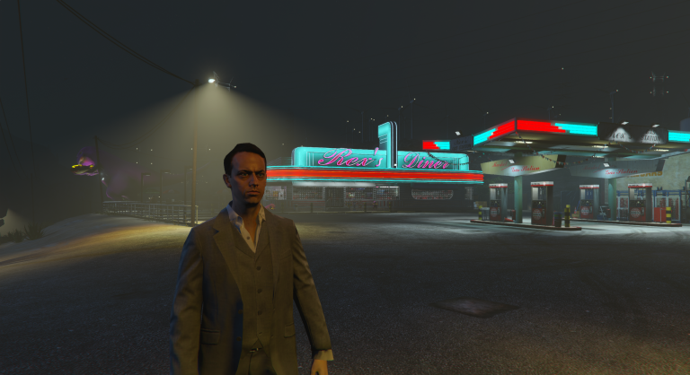 Jack Feebs outside a lit gas station in the fog at night