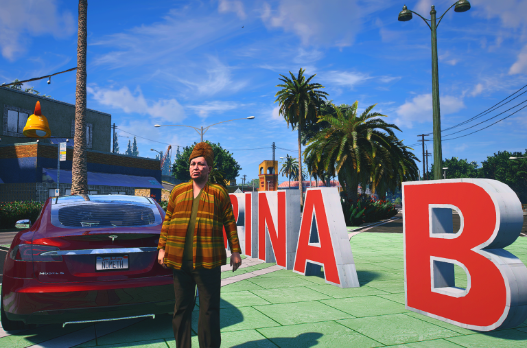 Jenny Craig in an orange flannel shirt beside a red car