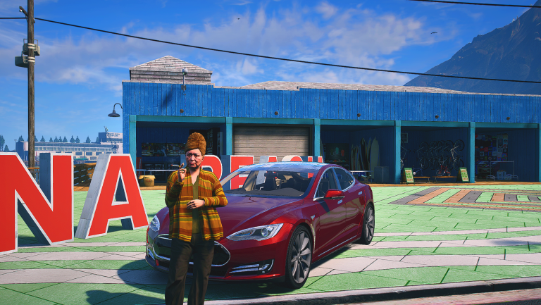 Jenny Craig standing by a red car at the Vespucci sign