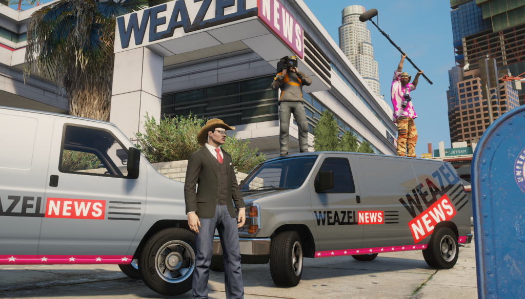 Chip Donovan in a fedora standing between two Weazel News vans